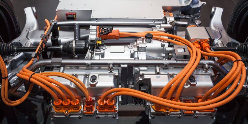 Electric engine and a traction inverter of battery electric vehicle (BEV), with high voltage wiring that connects EV battery, traction inverter and the engine.