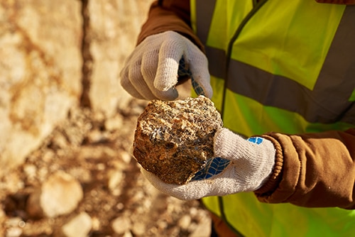 Close-up of a hand holding a rock.