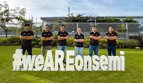 Six onsemi employees standing by a sign that says #weareonsemi.